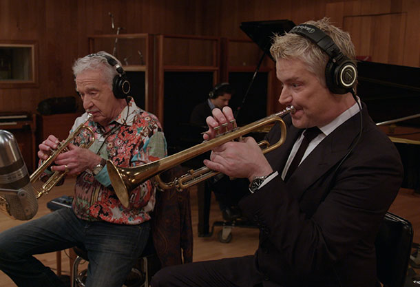 Photo of two men playing horns together