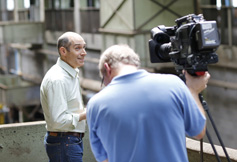 Photo of Geoffrey Baer and a cameraman. Link to Closely Held Business Stock. stock.jpg